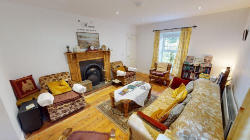 a living room with a couch and a fireplace at The Old Post Office Lodge in Enniskillen