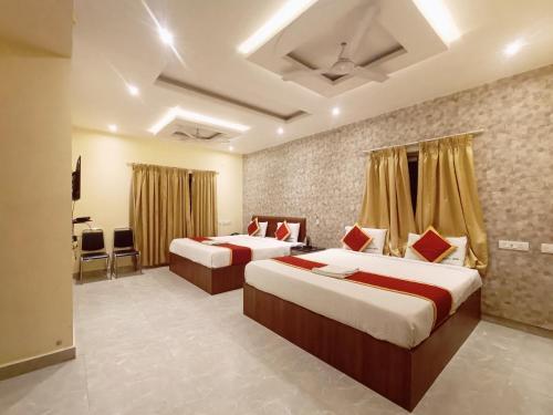 a hotel room with two beds in it at MRV Inn Triplicane in Chennai
