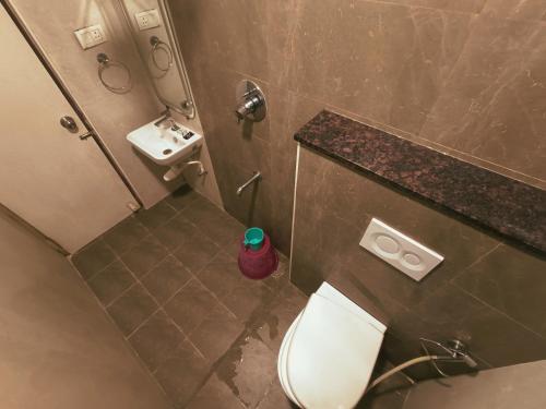 an overhead view of a bathroom with a toilet and sink at MRV Inn Triplicane in Chennai