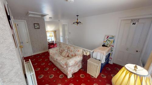 a living room with a couch and a chair at The Old Post Office Lodge in Enniskillen