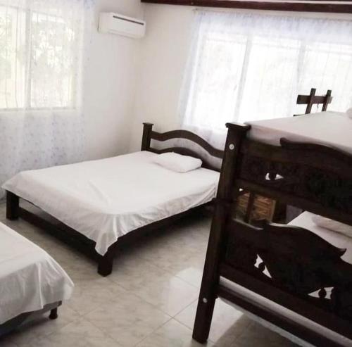 a bedroom with two bunk beds and a window at Finca Eccehomo in San Luis