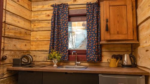 a kitchen with a sink and a window at Chalet Mountain Deer in Kolašin