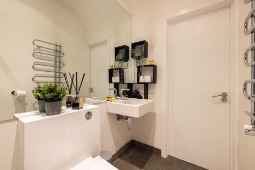 a white bathroom with a sink and a mirror at Charming Euston in London