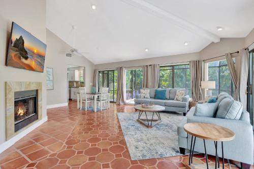 a living room with a couch and a fireplace at Subtropical Oasis -Naples Fl Retreat in Naples