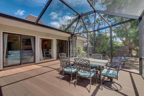 a patio with a table and chairs on a deck at Subtropical Oasis -Naples Fl Retreat in Naples