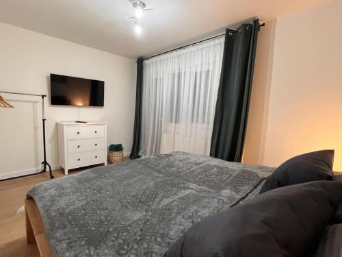 a bedroom with a bed and a large window at Alpine Escape by BOB in Cavnic