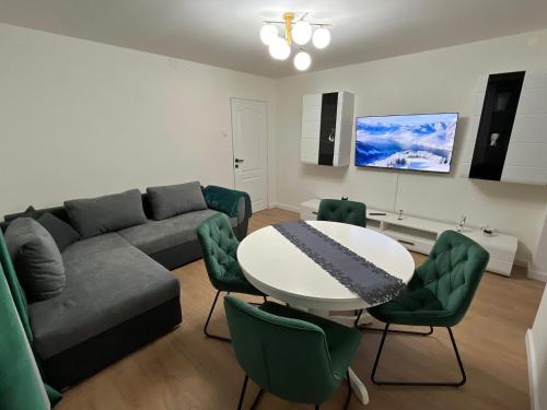 ein Wohnzimmer mit einem Sofa, einem Tisch und Stühlen in der Unterkunft Alpine Escape by BOB in Cavnic