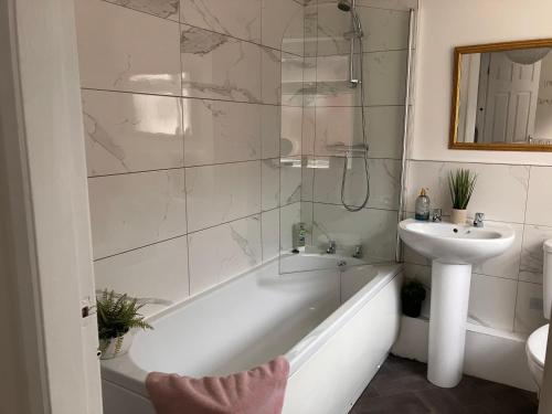 a bathroom with a sink and a bath tub and a sink at Sunderland Stays - Stadium of Light, City Central, HS WiFi, Secure Free parking, Smart TV in Monkwearmouth
