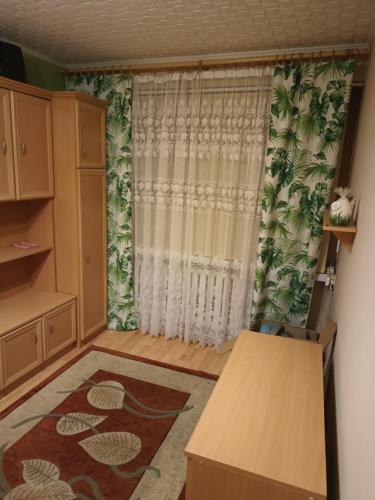 a living room with a curtain and a table at Mieszkanie 2pokojowe in Wieliczka