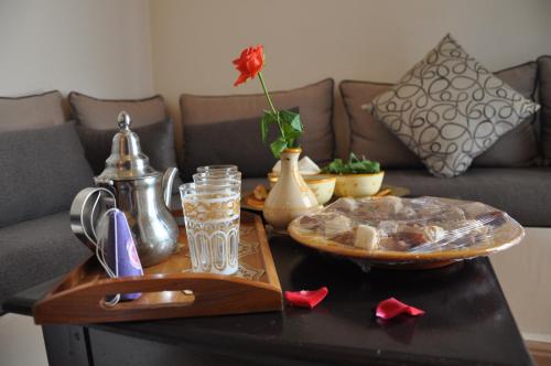 a coffee table with a plate of food on it at Riad Al Madina in Essaouira
