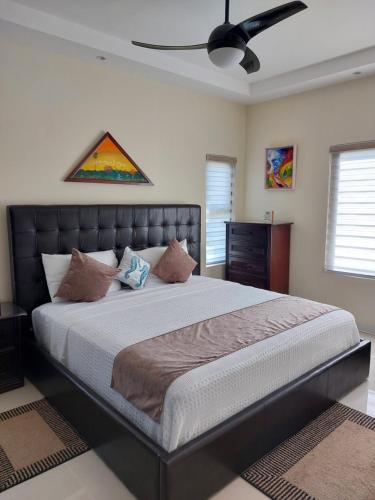 a bedroom with a large bed and a ceiling at PYRAMID JOY, 2 Bedroom Villa, Ocho Rios, Jamaica in Ocho Rios