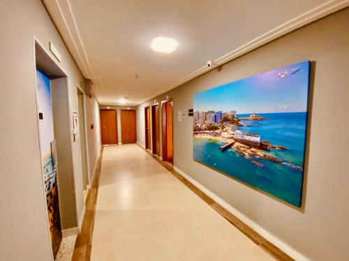 a hallway in a hotel with a large painting on the wall at Hotel Porto Salvador in Salvador
