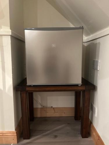 a tv sitting on a wooden table in a room at The Loft @ Kildare Village in Kildare