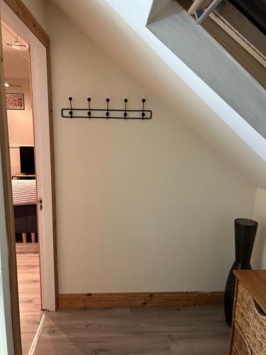 a hallway with a white wall with a black towel rack at The Loft @ Kildare Village in Kildare