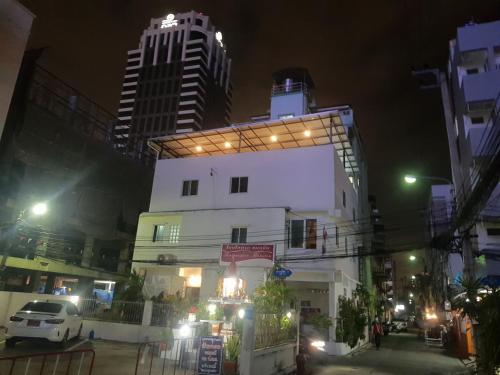 a white building with lights on top of it at night at BTL Sunny in Bang O