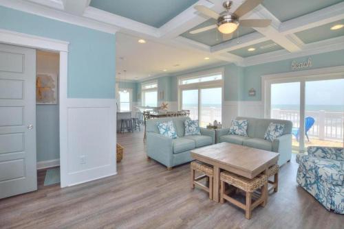 a living room with a couch and a table at Latitude Adjustment in Oak Island