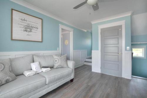 a living room with a couch and blue walls at Latitude Adjustment in Oak Island