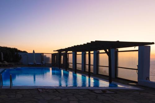 a swimming pool with a pergola on top of a building at Aegean Stones in Agios Ioannis Mykonos
