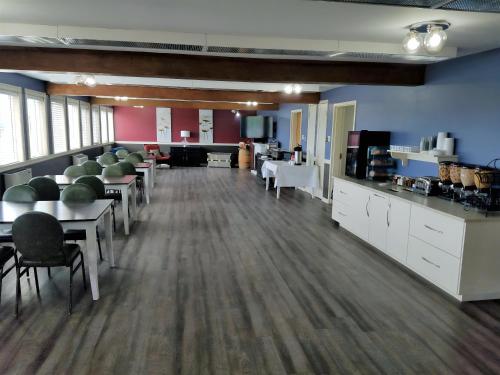 a large room with tables and chairs in a room at Ramada by Wyndham Florenceville in Florenceville