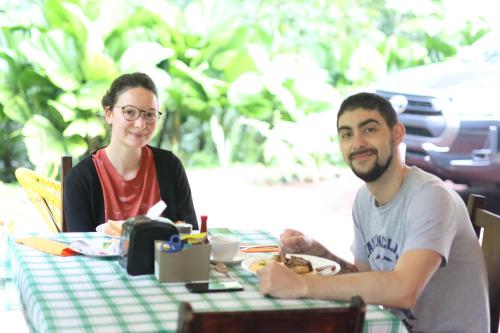 a man and a woman sitting at a table at Confort Arenal in Fortuna