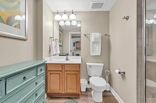 a bathroom with a toilet and a sink and a shower at Palms of Destin 21211 in Destin
