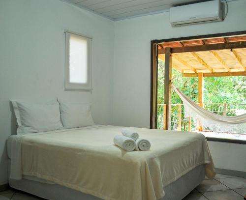 Un pat sau paturi într-o cameră la Lagoa Hospedaria