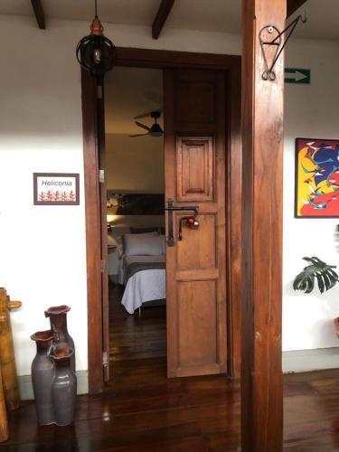 an open door to a bedroom with a bed at La Estancia Hotel Boutique in Salamina