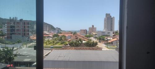 a view of a city from a window at Apartamento da Praia in Navegantes