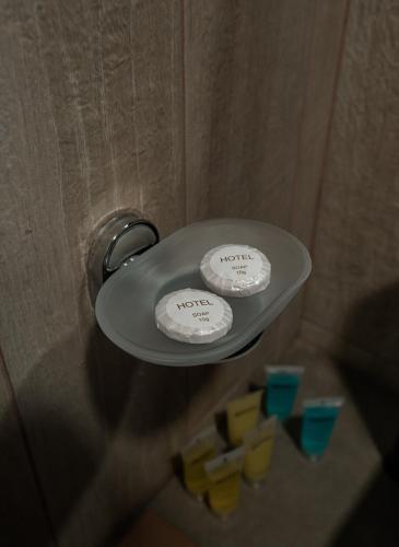 two towels are on a shelf in a bathroom at Lunisi Kvareli in Kvareli