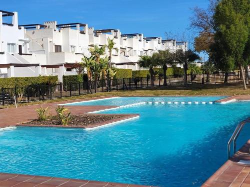 a blue swimming pool in front of a building at Condado de Alhama, Alhama de Murcia N549 in Murcia