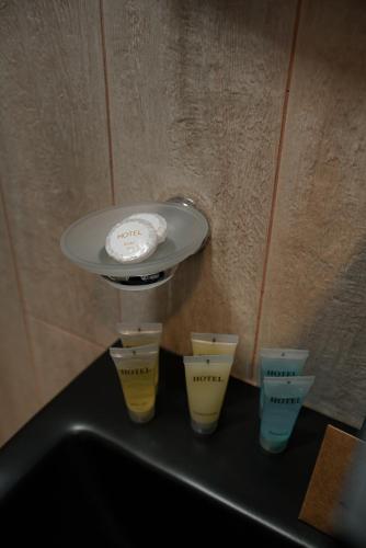 a sink with four cups and a white frisbee at Lunisi Kvareli in Kvareli