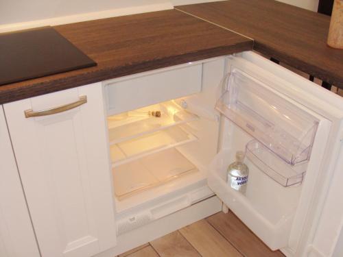 an open refrigerator with a bottle of water in it at Studio stonehouse in Ičići