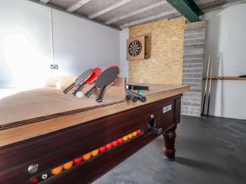a ping pong table with two chairs on top of it at Llys Tirion in Bala