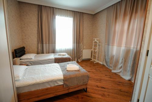 a hotel room with two beds and a window at Lunisi Kvareli in Kvareli