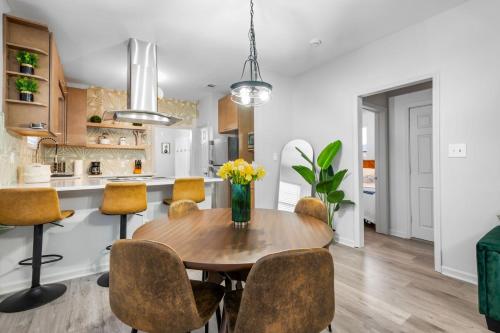 a kitchen and dining room with a wooden table and chairs at Near River St, Forsyth & DT - Stylish - Free Parking in Savannah