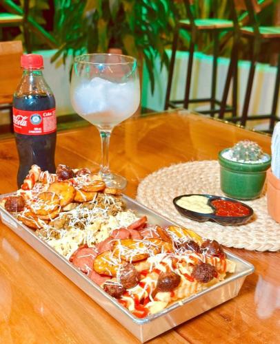a tray of pizza on a table with a glass of milk at Hotel Campestre Palmas del Zamorano in San Gil