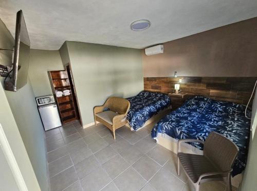 a bedroom with a bed and a chair in it at MARYAND in Soto la Marina