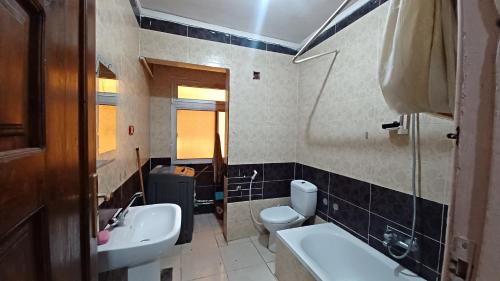 a bathroom with a sink and a toilet at Nice apartment in Cairo