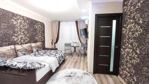 a bedroom with two beds and a window and a door at Квартира in Bender