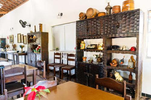 a dining room with tables and chairs and a counter at Hotel Morro De Santo Agostinho in Serra Negra