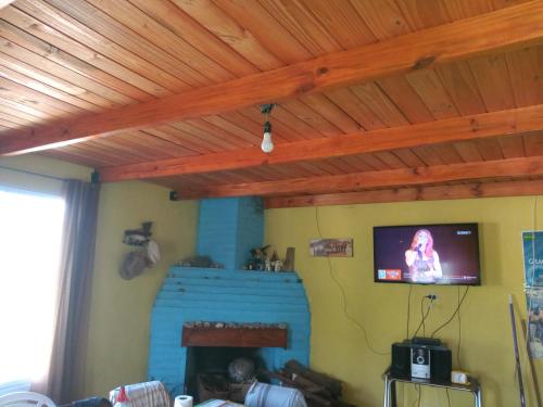 a living room with a flat screen tv on the wall at La Griselda in El Mollar