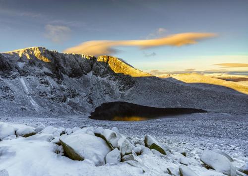 a view of a mountain with snow and rocks at The Crossing in Kingussie