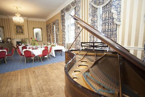 a room with a dining room with a table and chairs at Norfolk Arms Hotel in Arundel