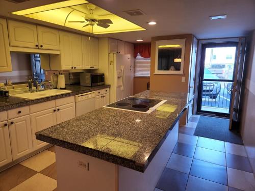 a kitchen with a sink and a counter top at 107 - 2/2 Poolside in Edgewater