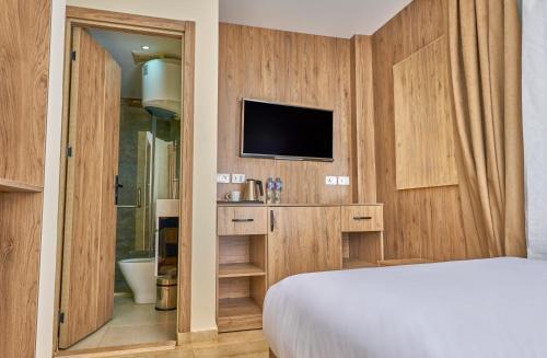 a hotel room with a bed and a television at Soul Pyramids View in Cairo