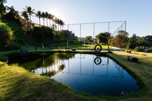 a pool of water with a clock in the middle at Hotel Morro De Santo Agostinho in Serra Negra