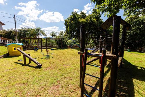 a park with a playground with a swing set at Hotel Morro De Santo Agostinho in Serra Negra