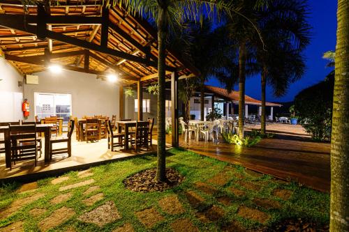 a restaurant with a table and chairs on a deck at Hotel Morro De Santo Agostinho in Serra Negra