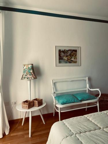 a bedroom with a bed and a table with a lamp at Miralago Casa Vacanze in Riva di Solto
