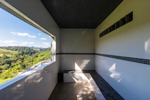 a room with a window and a view at Hotel Morro De Santo Agostinho in Serra Negra